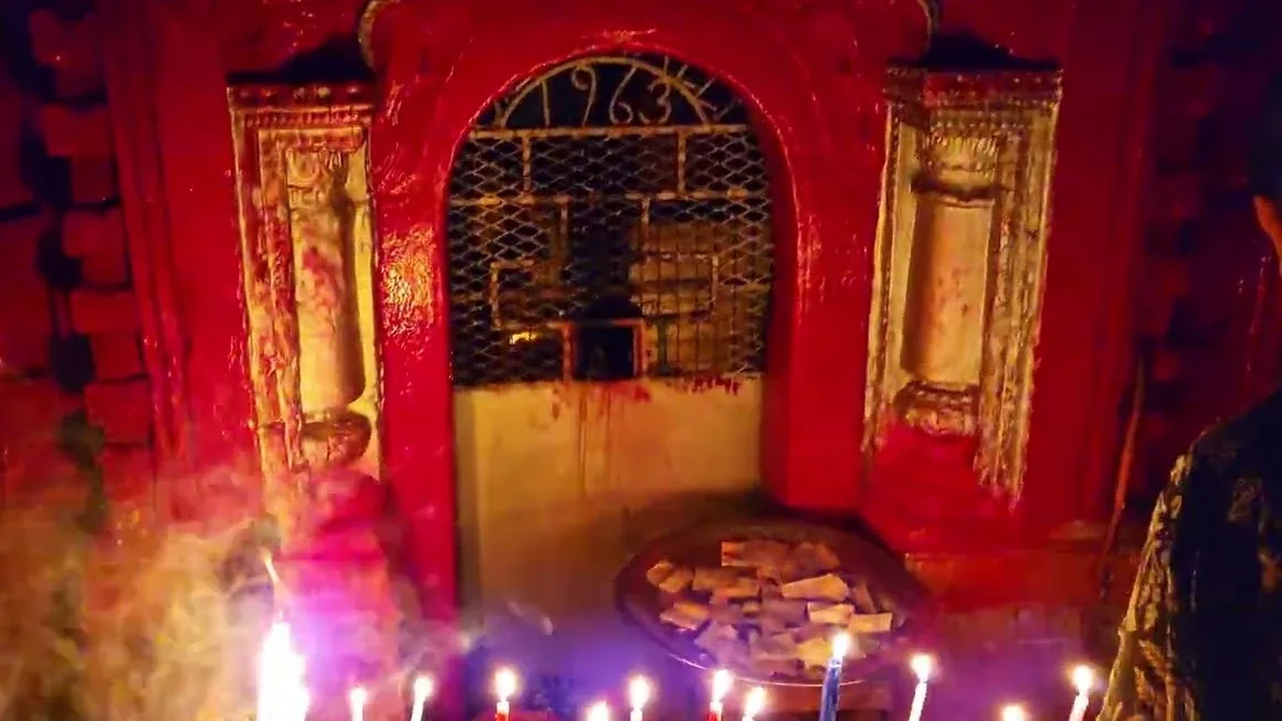 Lamps lit before a shrine at Tarapith